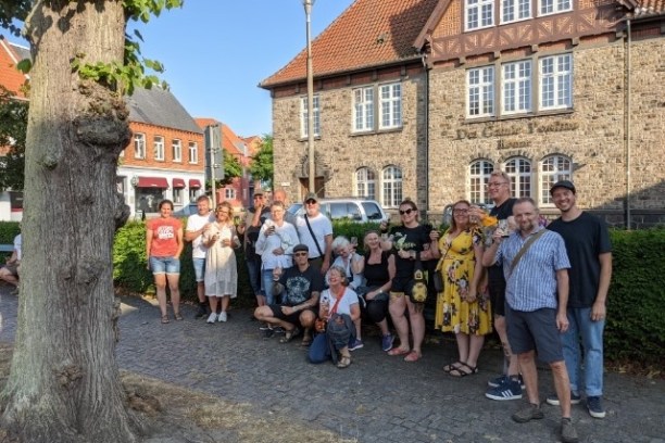 a group of people standing in front of a brick building
