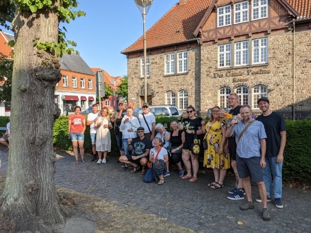 Bornholm BeerWalk (Rønne) Image 3 a group of people standing in front of a brick building