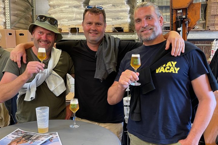 a group of people standing around a table
