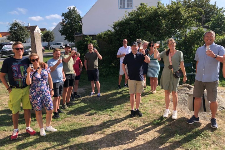 a group of people standing in the grass