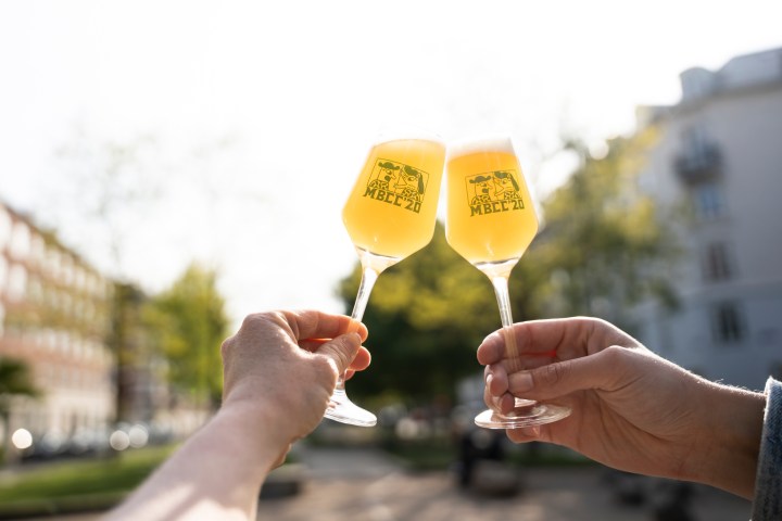a hand holding a glass of wine