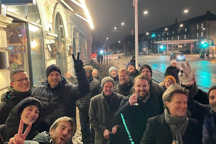 a group of people standing in front of a crowd posing for the camera