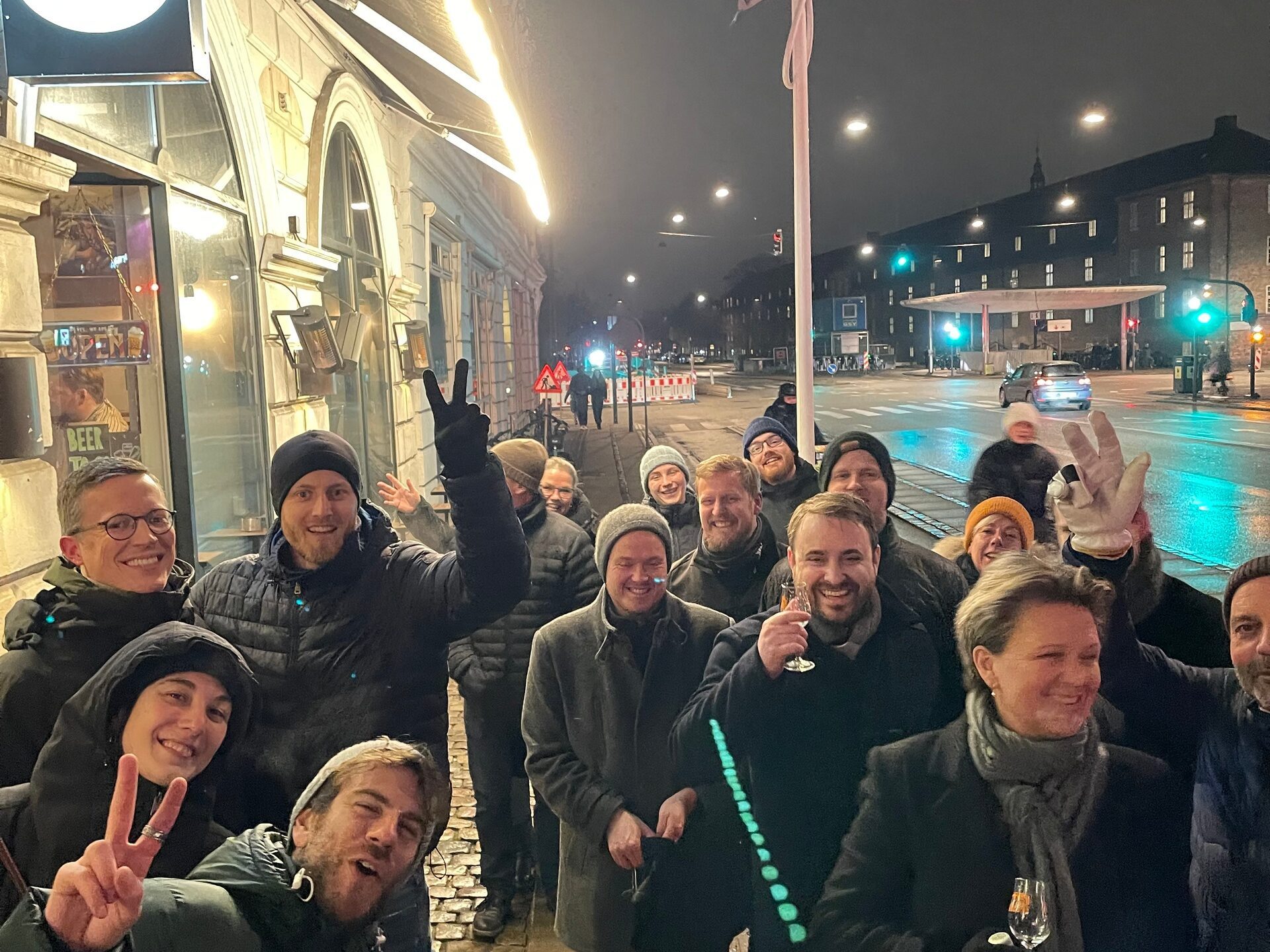 a group of people standing in front of a crowd posing for the camera