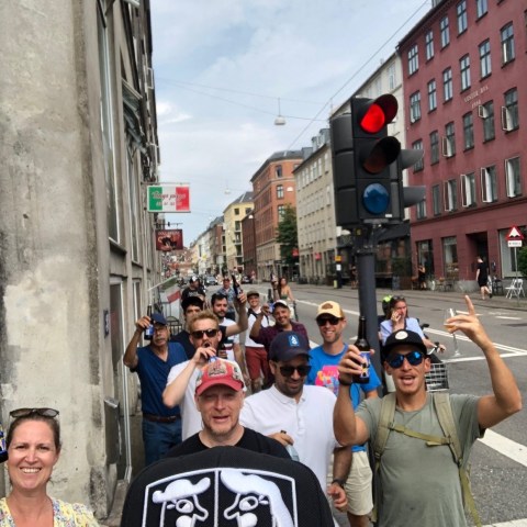 a group of people standing next to a traffic light on a city street