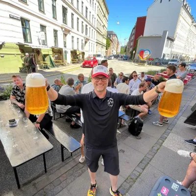 Christoffer BeerWalks in front of group of feople