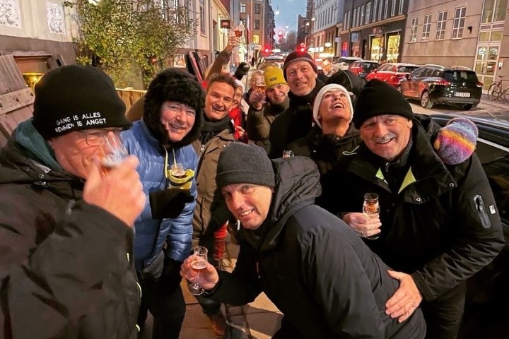 a group of people standing in front of a crowd posing for the camera