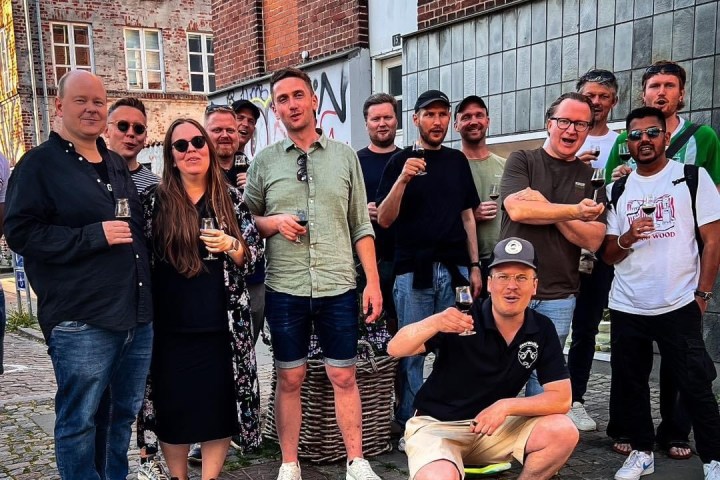 a group of people standing on a sidewalk