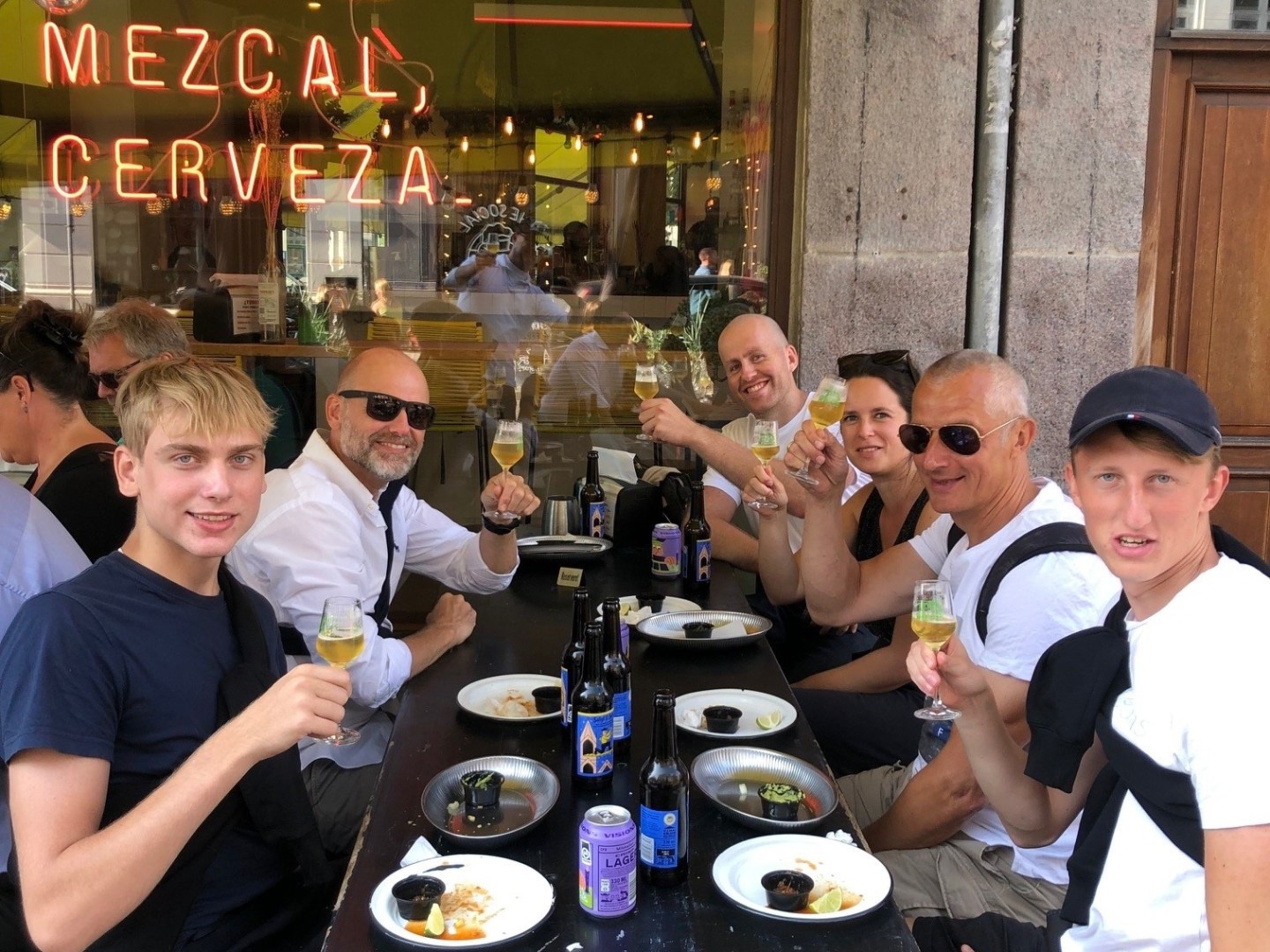 a group of people sitting at a table in a restaurant