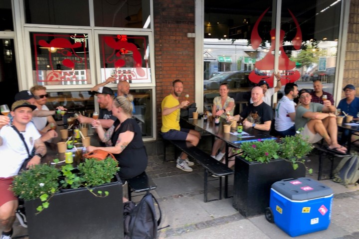 a group of people sitting in front of a building