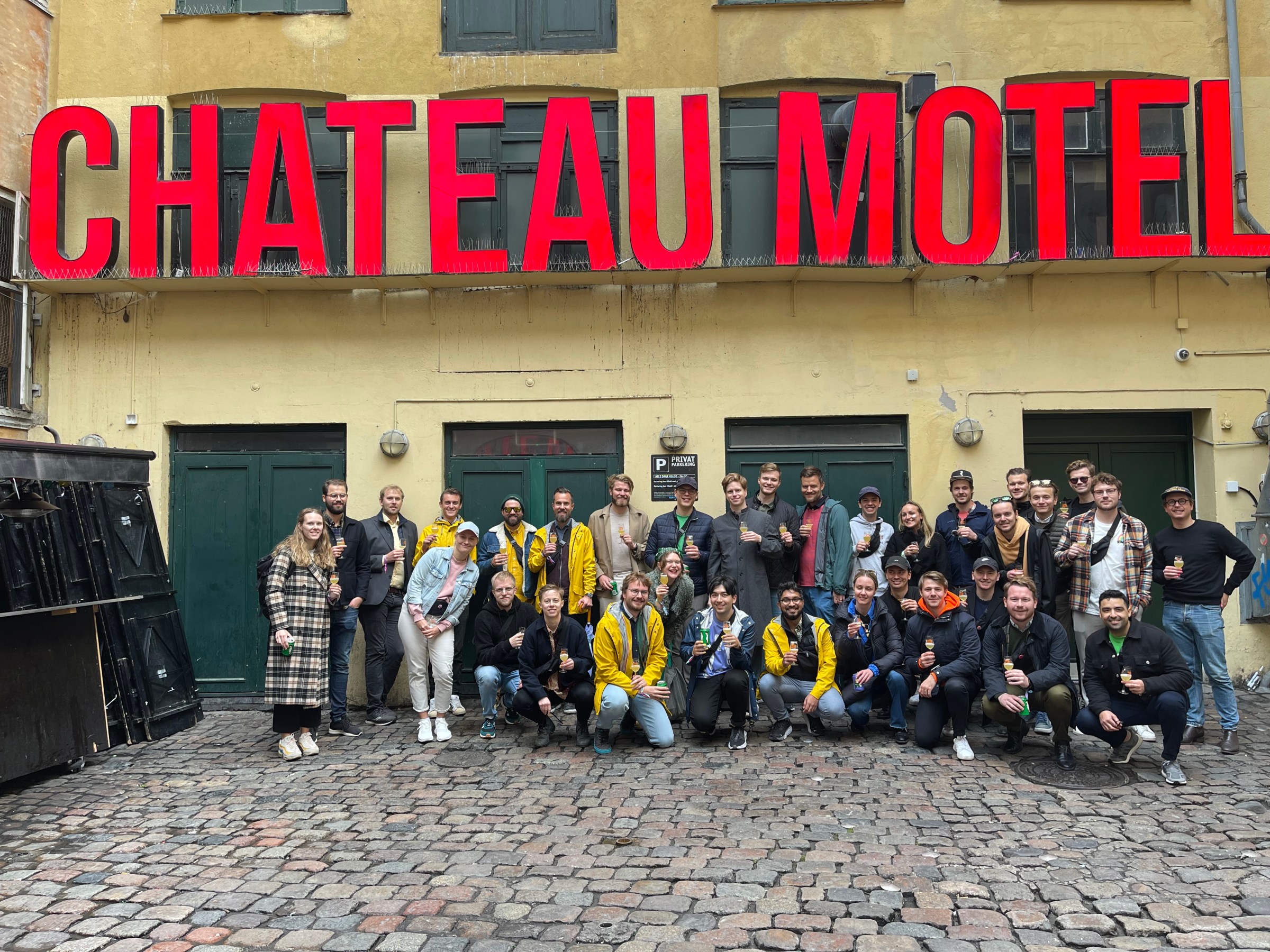 a group of people standing in front of a sign